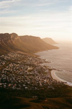 Coastal town nestled at the base of mountains.